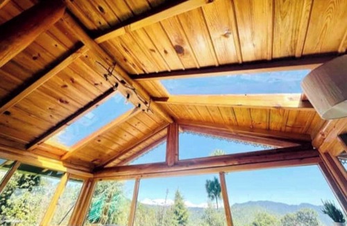 Almora House | Cozy bungalow nestled in the Himalayas, snow-capped peaks, Kumaoni culture.