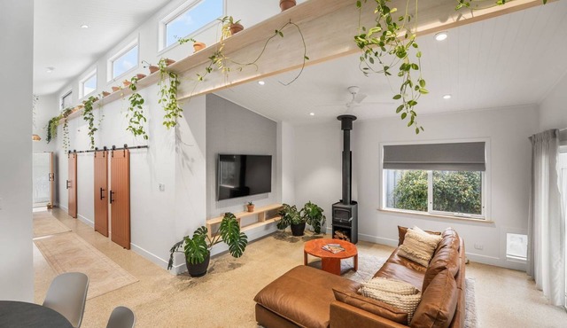 Designer coastal home with magnesium pool. Walk to cafes, beach, pet friendly.