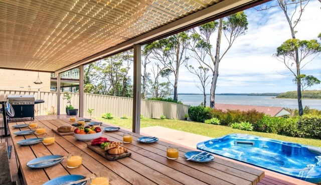 Sandy C - immaculate modern home with outdoor spa and stunning lake views.